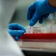 Midsection of a laboratory scientist analyzing chemical substances in a research lab.