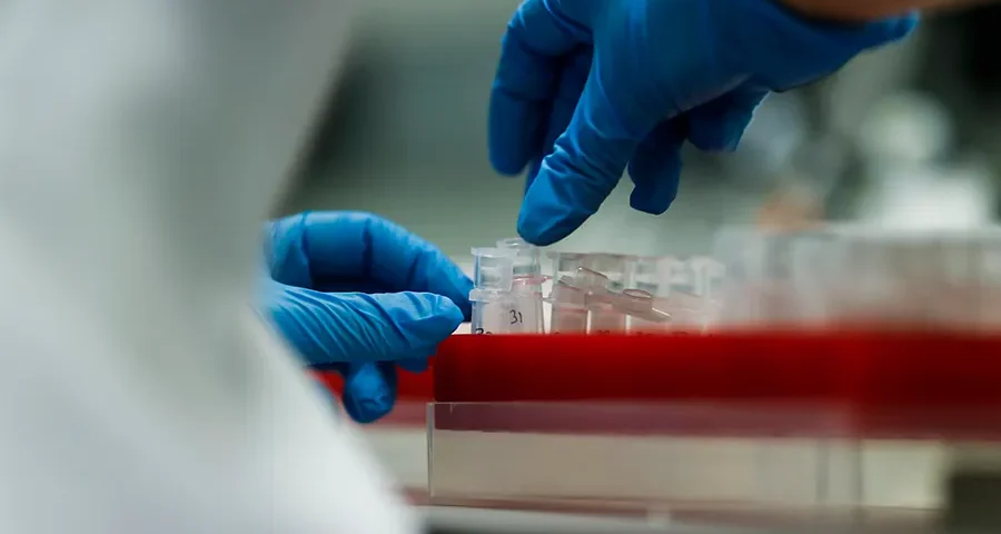 Midsection of a laboratory scientist analyzing chemical substances in a research lab.