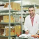 Medical supply warehouse with workers organizing products and preparing shipments.