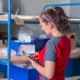 Female worker handling logistics near a container, involved in medical supply distribution.