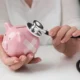 Stethoscope placed on piggy bank symbolizing urgent cost-effective medical solutions.