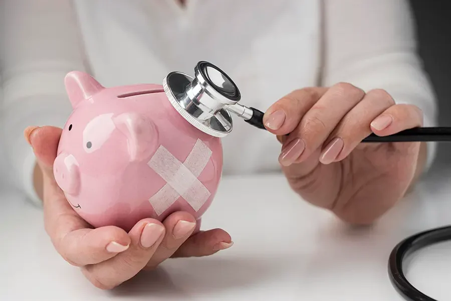 Stethoscope placed on piggy bank symbolizing urgent cost-effective medical solutions.