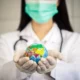 Female doctor holding globe, symbolizing sustainable use of medical resources.