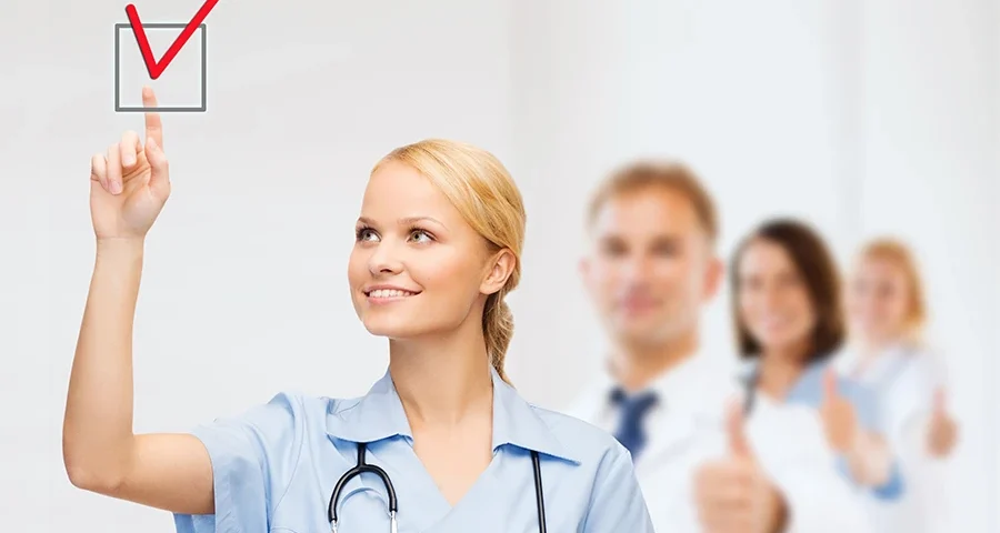 Young healthcare professional marking a checkbox, indicating verified medical supplies.