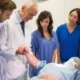 Medical students and instructor performing a hands-on training session by checking a pulse.