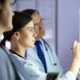 Group of doctors analyzing X-ray films together in a clinical setting, discussing possible diagnoses.