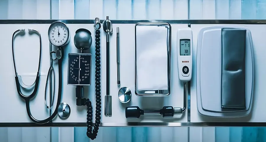 Assorted medical devices arranged on a table, intended for educational use in training simulations.