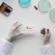 Close-up of a scientist using a pipette, ideal for illustrating lab practice with expired or surplus materials.