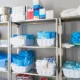 Organized storage room in a clinic with surplus medical equipment and supplies for institutional use.