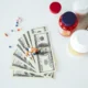 Money with pills and vitamins representing medical education costs and budgeting.