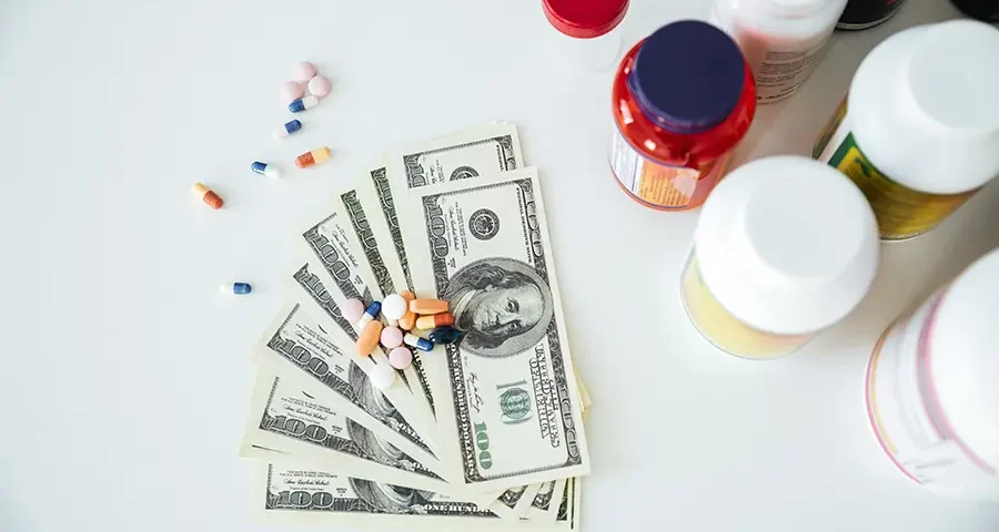 Money with pills and vitamins representing medical education costs and budgeting.
