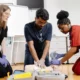 Healthcare professionals or students practicing hands-on medical procedures in a training environment
