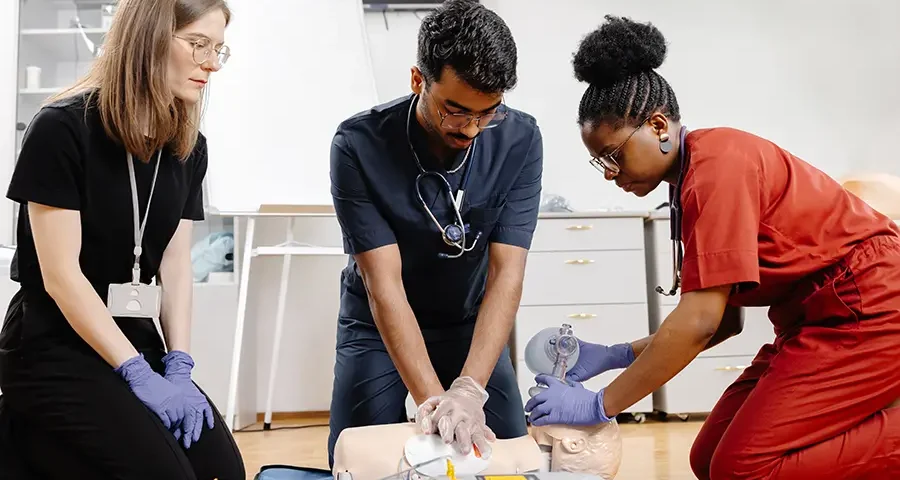 Healthcare professionals or students practicing hands-on medical procedures in a training environment