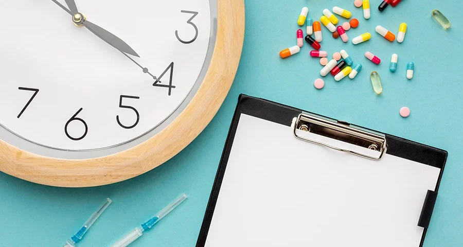 Clipboard with medical form and various medications on a blue background, representing inventory or soon-to-expire medical supplies